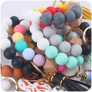 Macro shot of colorful silicone beaded keychain bracelets with decorative tassels and charms