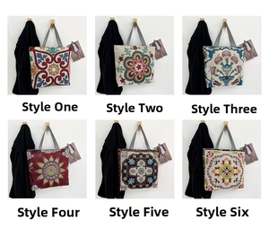 Detail view of ethnic embroidery patterns and striped handles on six canvas tote bags
