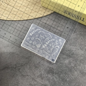 Detail view of silicone nail art mold with sea star and shell patterns for manicure