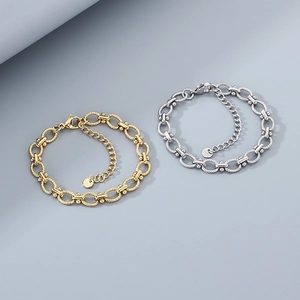 Close-up of gold and silver stainless steel oval link bracelets with S925 engraved tags