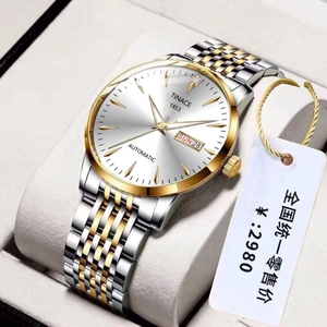 Macro view of automatic mechanical watch with dual calendar display and two-tone steel band