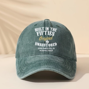Detail of vintage washed green baseball cap featuring retro English typography and texture