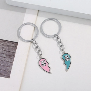 Cute panda heart keychain set for couples featuring pink and blue enamel metal pendants