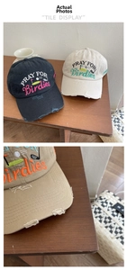Close-up of vintage distressed cotton baseball cap with PRAY FOR Birdies embroidery