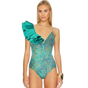 Detailed view of the one-shoulder tiered turquoise ruffle and bohemian paisley print