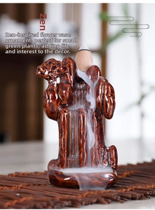 Close-up of ceramic backflow incense burner showing smoke flowing over dark glazed texture