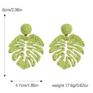 Detail view of handmade green raffia leaf earrings with precise dimensions and natural texture