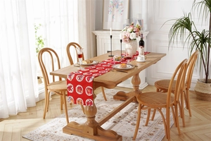 Close-up of red Christmas table runner with festive cartoon animal prints in a home setting