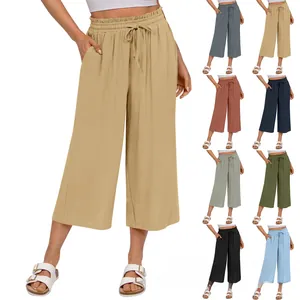 Detail showing elastic high waist with drawstring on linen wide leg pants in khaki color