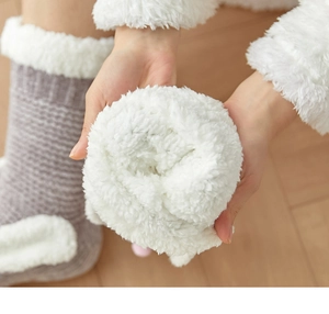 Close-up of cozy grey knitted winter socks with soft white lamb wool lining detail