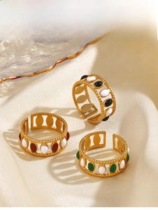 Detailed macro of gold plated stainless steel open rings with colorful enamel inlays