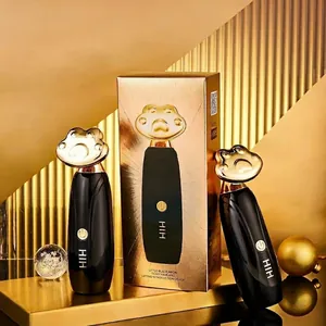 Electric facial lifting massager in black and gold finish with cat paw design