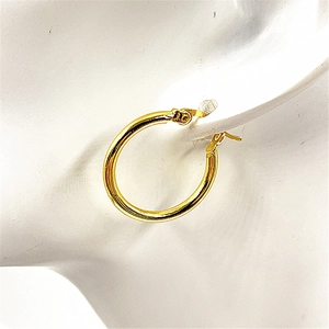 Macro detail of minimalist gold hoop earring on model showing high polish and elegant design