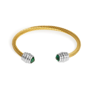 Gold cable twist cuff bracelet featuring silver caps and emerald cut green gemstones