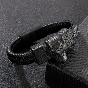 Men's braided black leather bracelet featuring a detailed steel wolf head and magnetic clasp