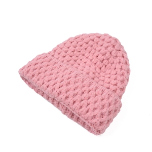 Close-up of pink chunky knit beanie showing thick pineapple texture and folded cuff