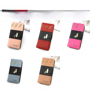 Detail view of long bifold purses in five colors featuring hollow leaf patterns and pendants