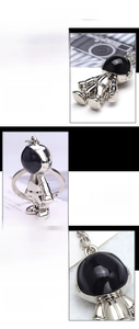 Detail showing polished silver astronaut keychain made of zinc alloy with black enamel