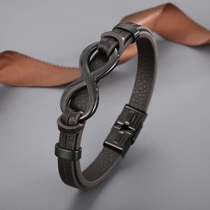 Detail view of brown braided leather bracelet with black infinity symbol clasp