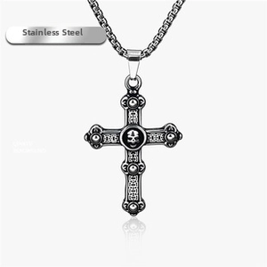 Detailed view of stainless steel skull cross necklace with vintage black carved finish