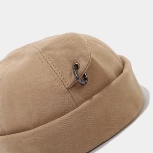 Khaki cotton docker hat with side ear flap and industrial metal ring detail