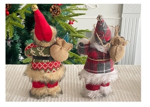Close-up of Santa figurines with burlap gift bags and plush knit texture details