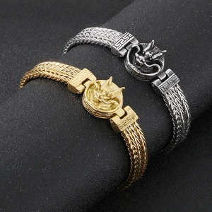 Macro shot of punk style dragon-shaped steel bracelets in gold and silver finish
