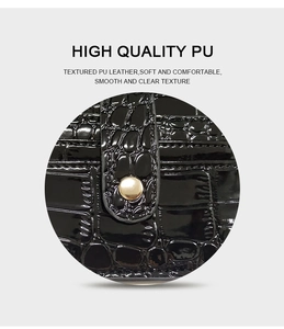 Macro shot of high quality black crocodile textured PU leather showing soft smooth surface