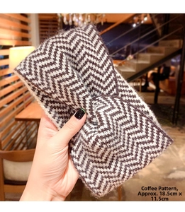 Close-up of coffee striped knitted headband for women measuring 18.5cm by 11.5cm