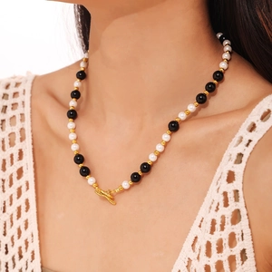 OT toggle necklace with black onyx and white shell beads in gold plated titanium steel