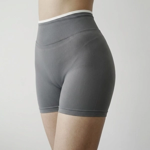 Close-up of high-waist seamless yoga shorts with white contrast trim and ribbing