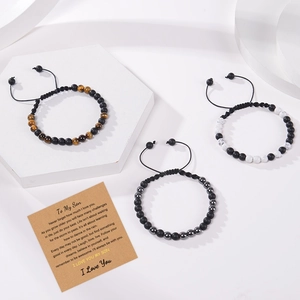 Close-up of beaded bracelets with natural stones and an inspirational message card