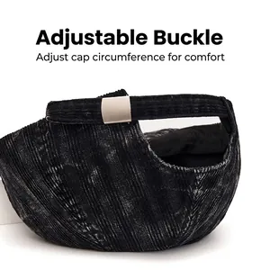 Adjustable silver metal buckle on the back of a black corduroy baseball cap for custom fit