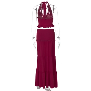 Back view of burgundy two-piece set featuring halter neck top and tiered maxi skirt