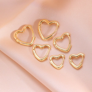 Three pairs of golden heart-shaped hoop earrings in small, medium, and large sizes