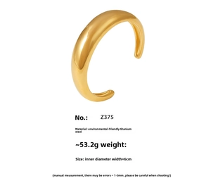 Macro shot of 18K gold plated titanium steel C-shape cuff bracelet with polished finish