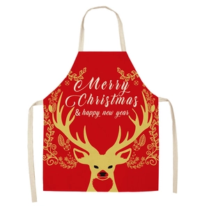 Detail of red linen Christmas apron with golden reindeer print and festive text