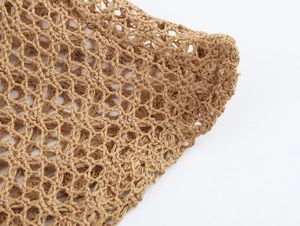 Close-up of brown crochet mesh fabric texture showing detailed woven knit for beachwear
