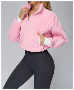 Close-up of pink fleece pullover featuring a stand collar and white ribbed cuffs texture