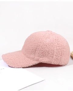 Detailed macro view of the soft pink sherpa fleece texture on a warm baseball cap