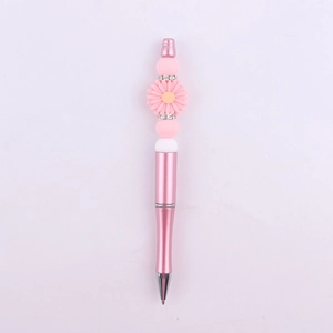 Detail of pink metal beaded pen with silicone daisy flower and rhinestone spacers