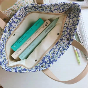 Internal view of floral canvas tote bag showing zipper pocket and spacious lining
