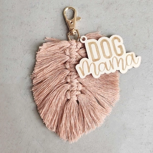 Detail of pink woven tassel keychain with golden clasp and Dog Mama wooden tag