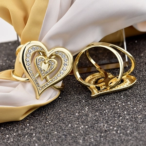 Macro view of golden heart-shaped scarf clip with sparkling rhinestone inlay details