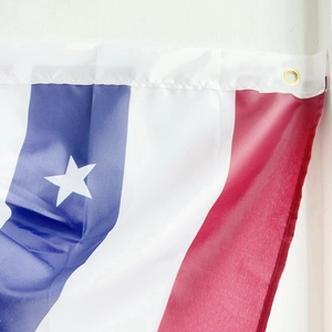 Close-up of US pleated fan flag with durable synthetic fabric and a golden metal grommet