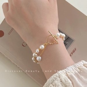 Elegant double-layered baroque natural pearl bracelet with a golden metal OT toggle clasp