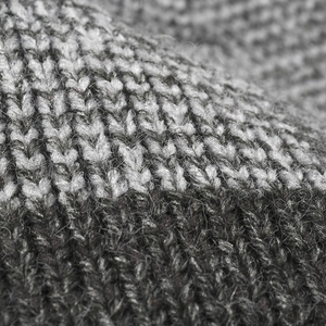 Outdoor thermal knit beanie featuring thick black and grey blended wool yarn texture