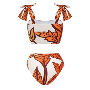Detail of tropical leaf print bikini with wooden beads on adjustable shoulder straps