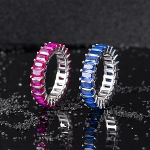 Macro detail of S925 silver eternity rings with emerald-cut blue and pink gems