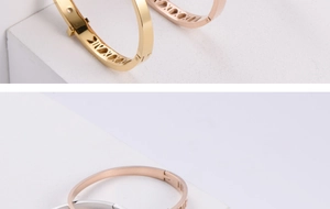Macro shot of geometric hollow roman numeral bangle with polished buckle in three colors